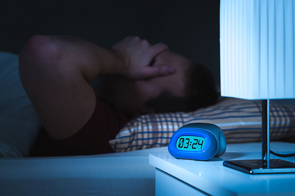 Overweight man having trouble sleeping.