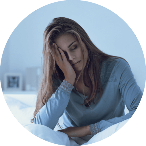 Woman lying awake in bed unable to get restful sleep