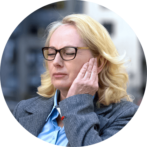 "Woman holding her jaw in pain from a TMJ disorder